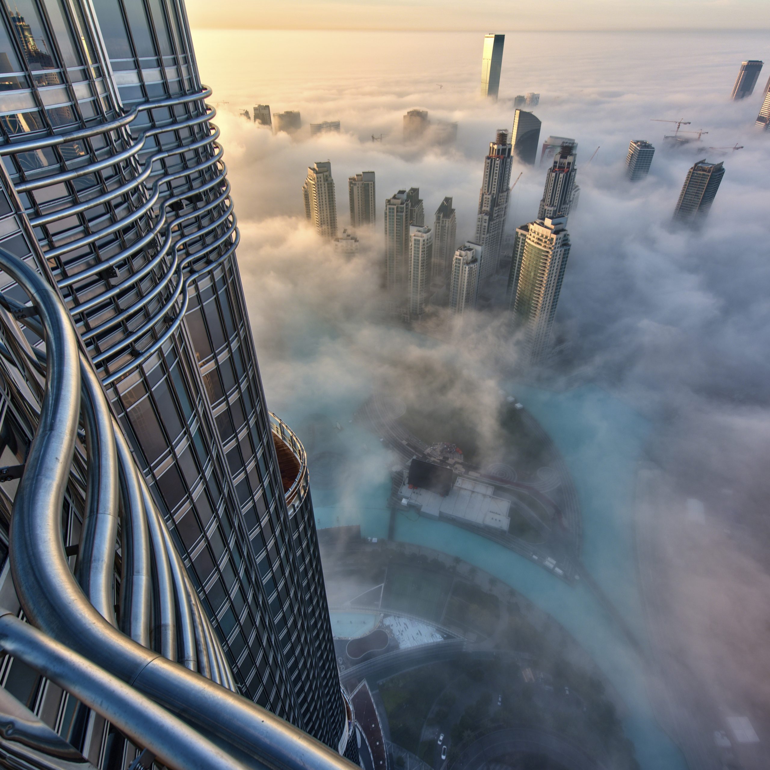 Aerial view of cityscape with skyscrapers above the clouds in Dubai, United Arab Emirates.